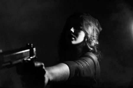 woman holding gun attack